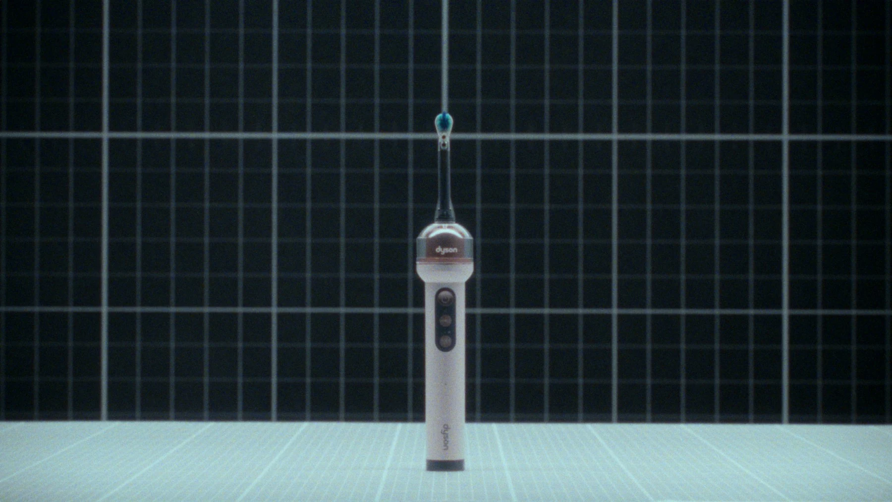 The official Dyson CameraJet toothbrush standing on a lab grid, from the product page