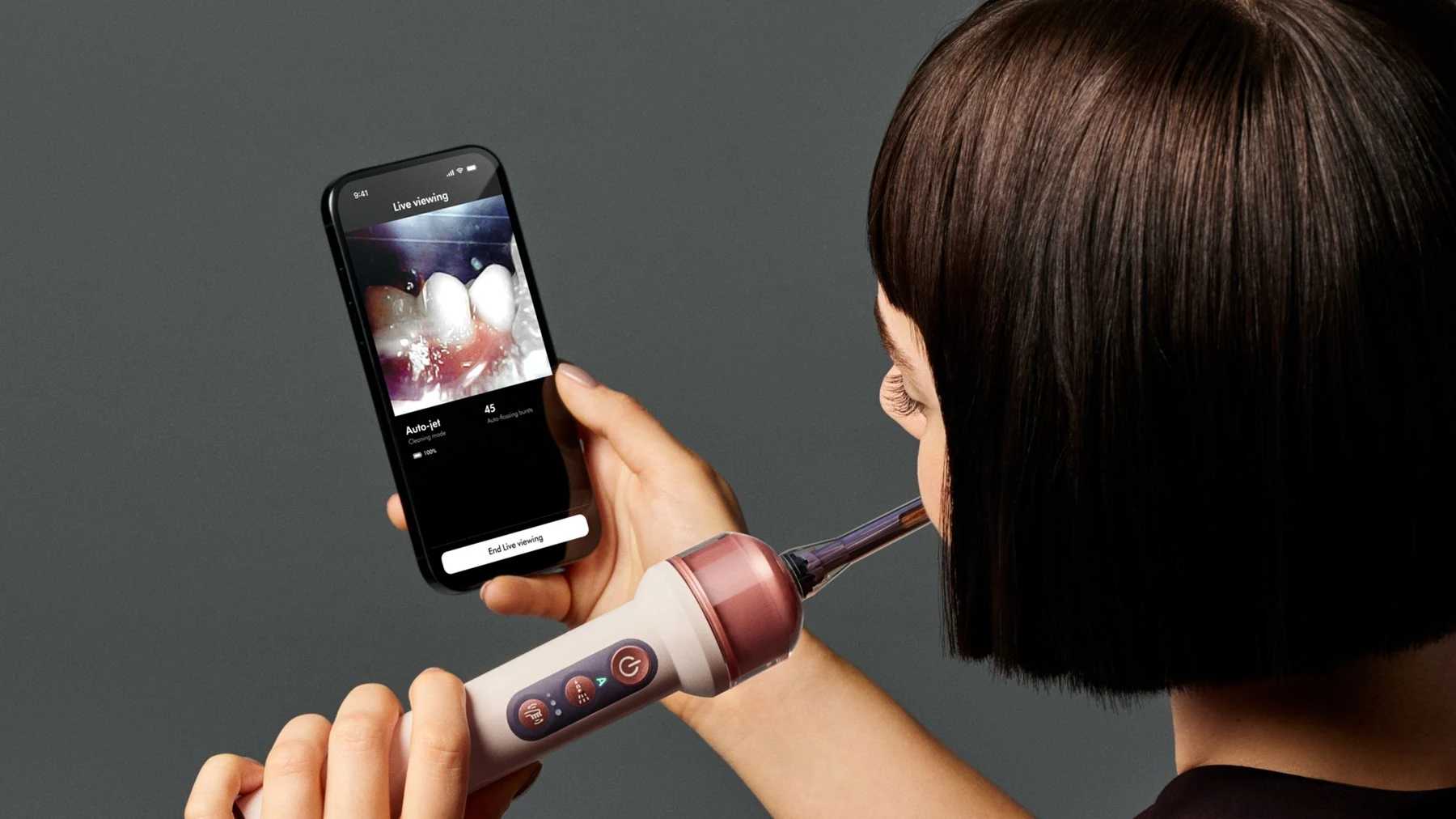 A person using the CameraJet with the MyDyson app live view, from the official product page