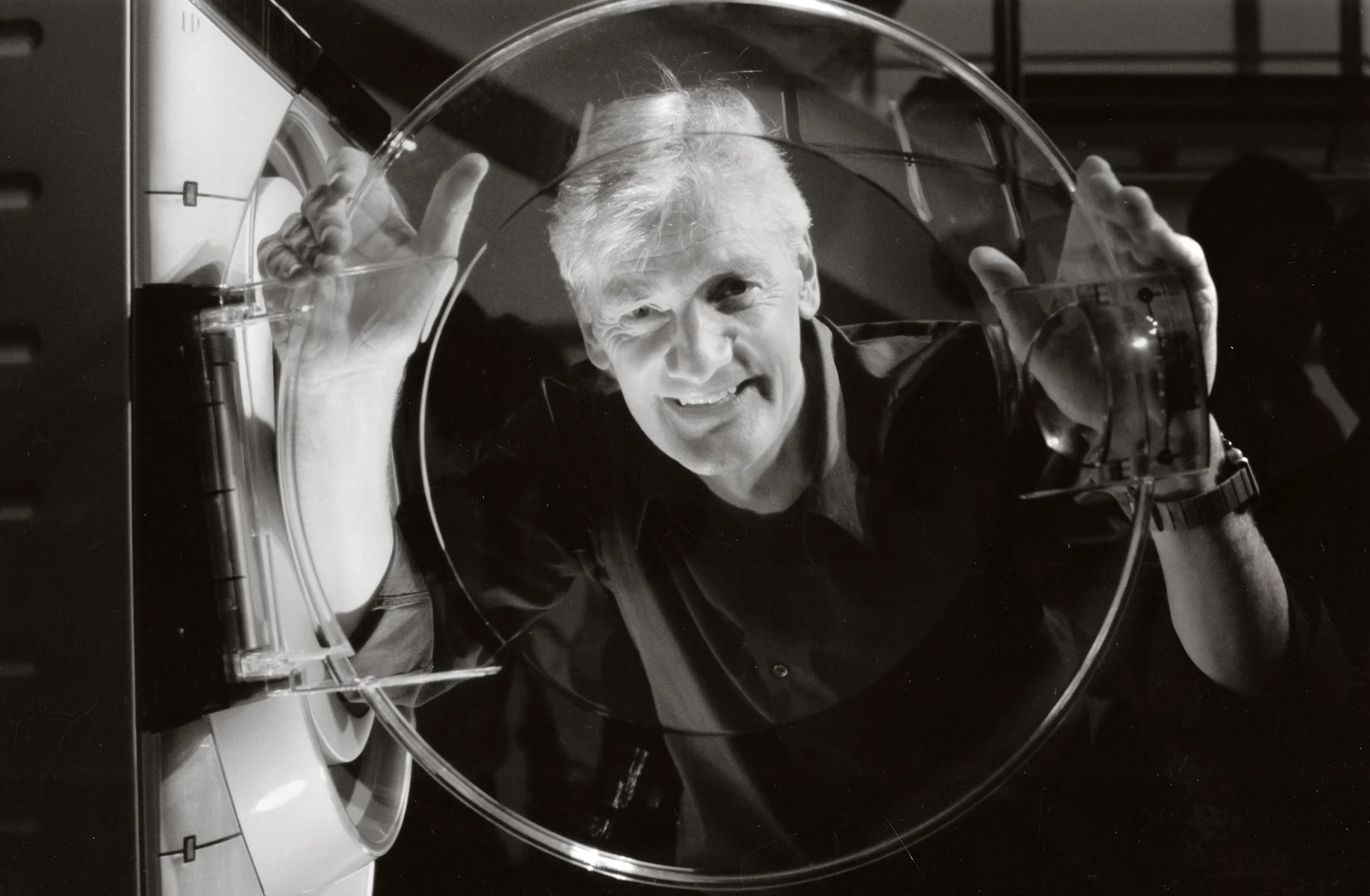 James Dyson looking through the door of a ContraRotator washing machine