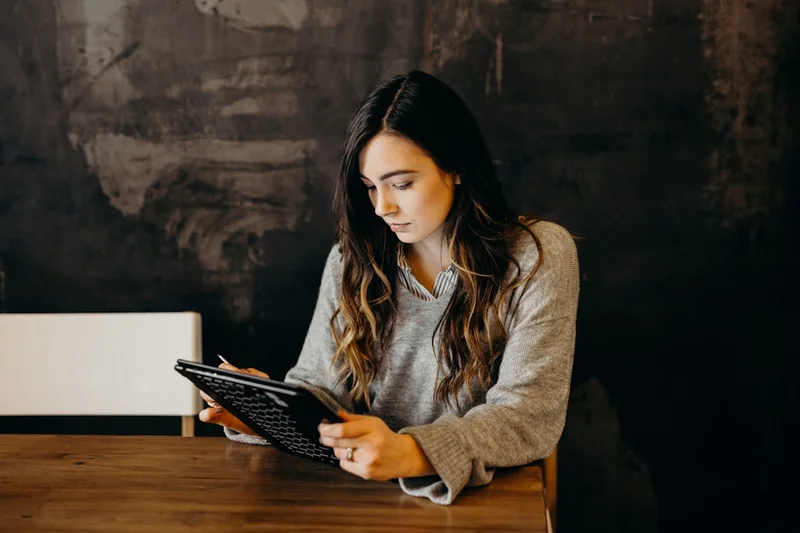 Photographer reviewing email marketing platform options on laptop