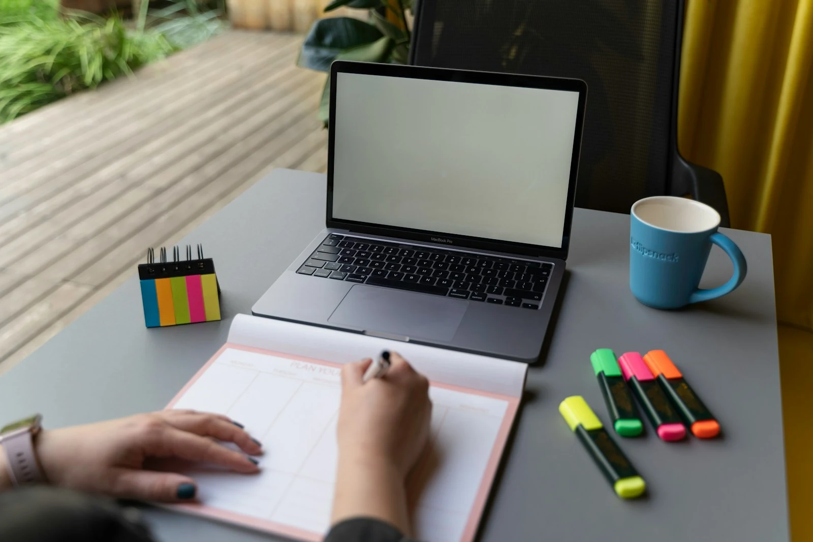 Photographer reviewing their booking calendar and referral system on a laptop — building a systematic referral marketing program