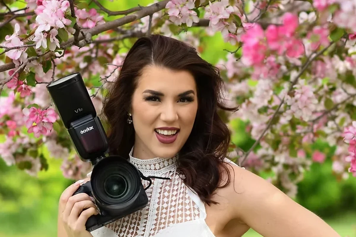 Portrait photographer Quinn Teechma holding her camera