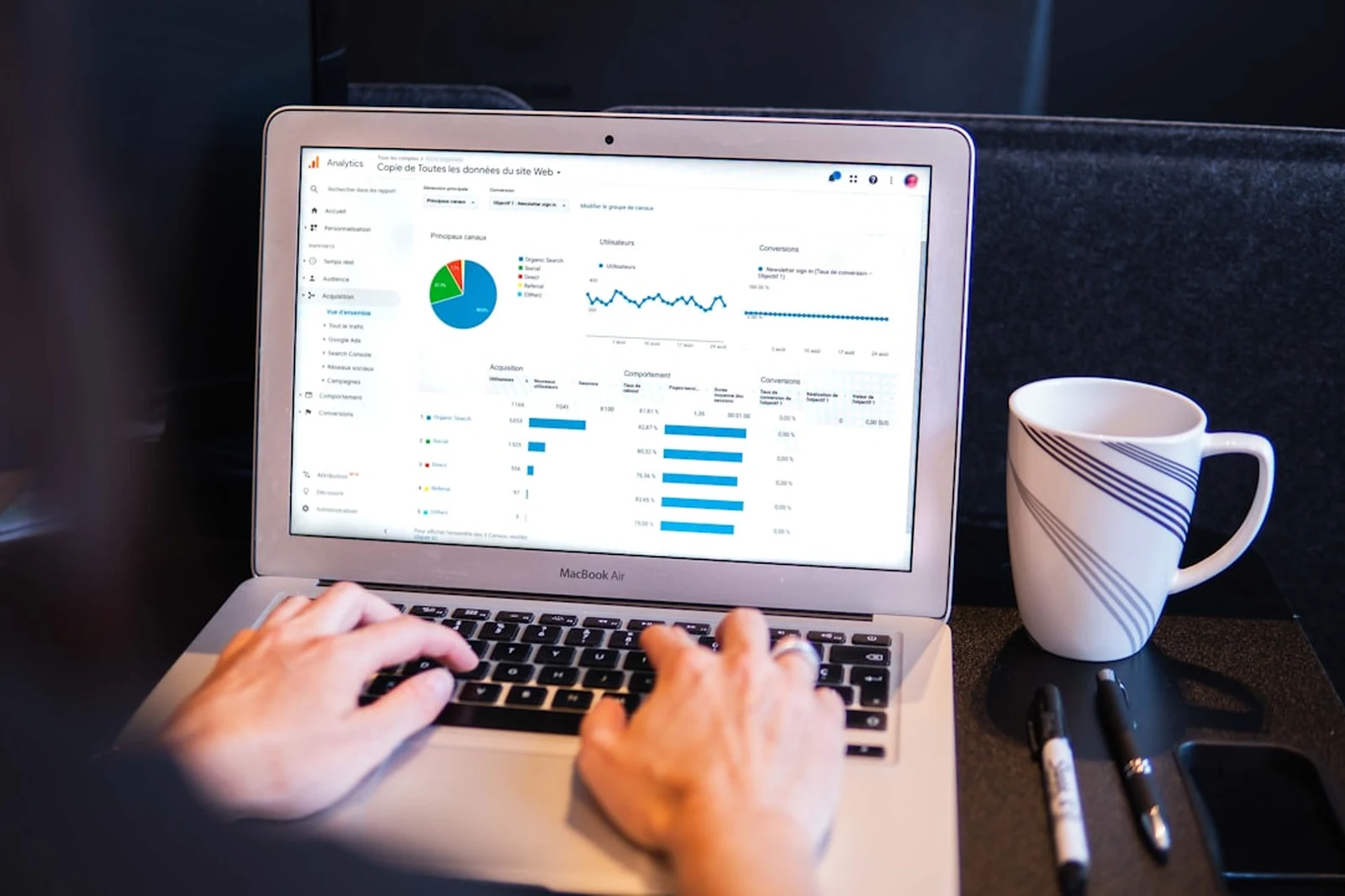 Photographer doing keyword research on laptop with analytics data — SEO keyword strategy for photography businesses